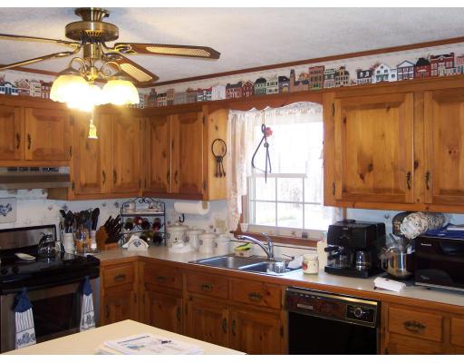 309 Mason Rd Extension Dudley, MA 01571 - Photo 4 of 13 a kitchen with a sink a refrigerator and cabinets