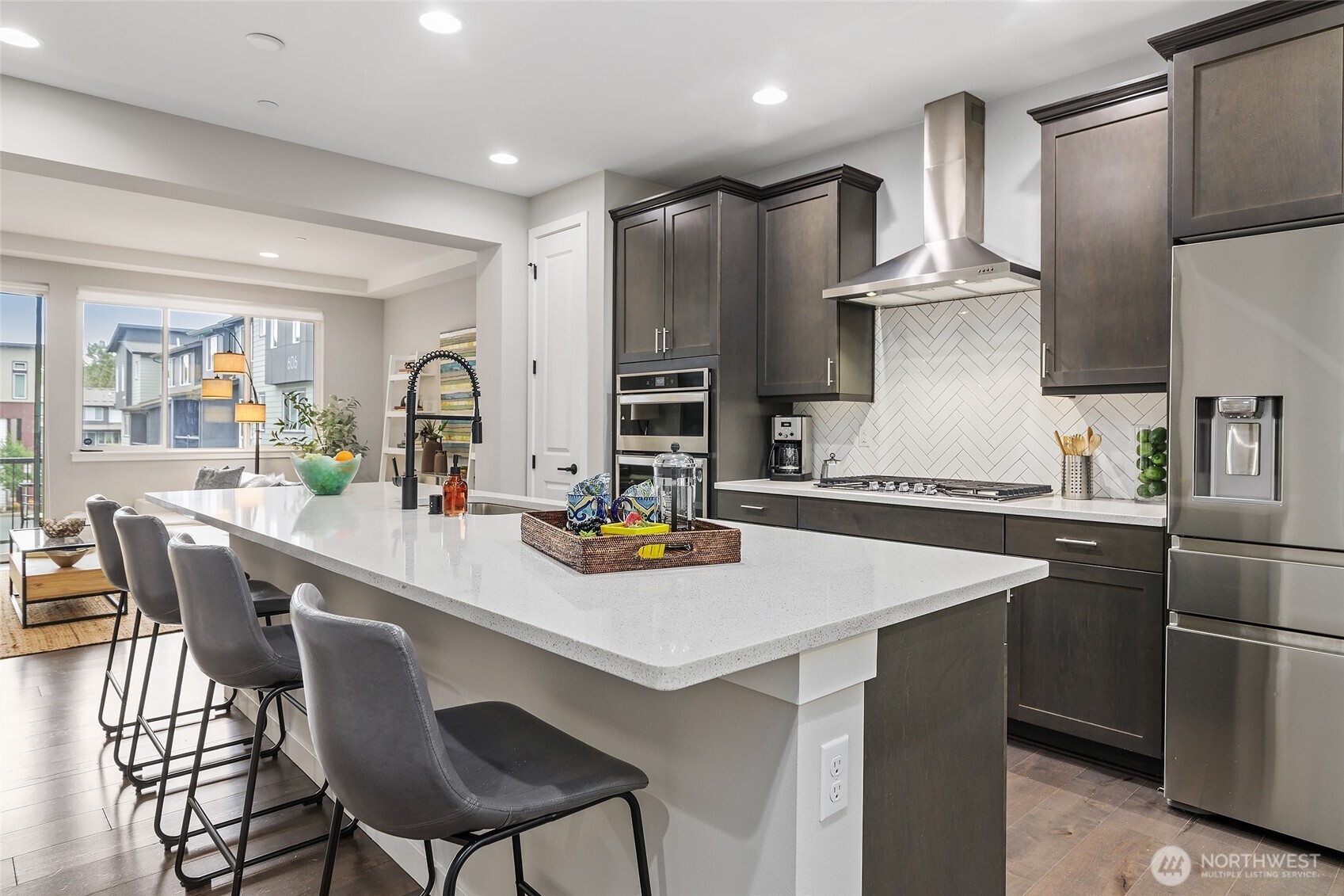 23630 6th Avenue Southeast, Unit B Bothell, WA 98021 - Photo 12 of 40 a kitchen with stainless steel appliances granite countertop a sink a stove a refrigerator and chairs