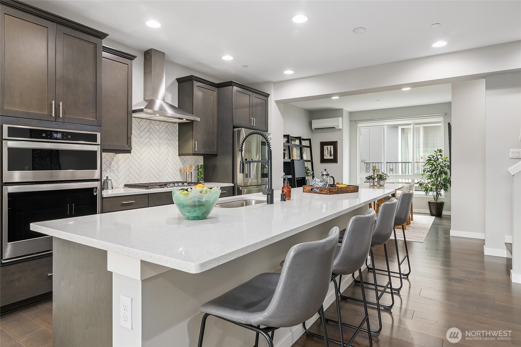 23630 6th Avenue Southeast, Unit B Bothell, WA 98021 - Photo 14 of 40 a kitchen with stainless steel appliances kitchen island granite countertop a kitchen island and chairs in it