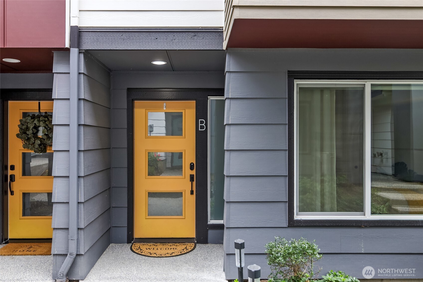 23630 6th Avenue Southeast, Unit B Bothell, WA 98021 - Photo 3 of 40 a front view of a house with a blue gate