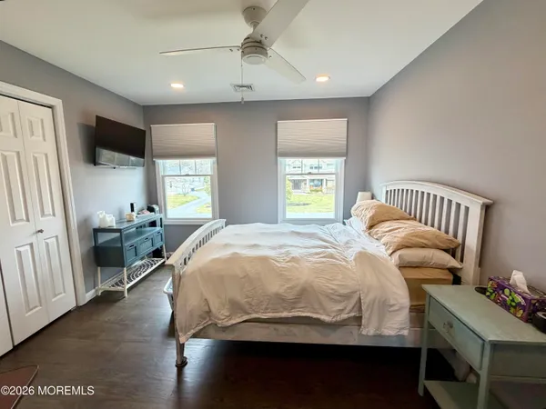 a spacious bathroom with a toilet sink and mirror