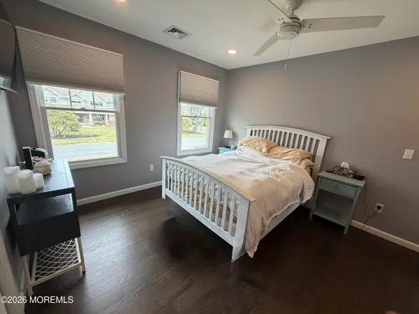 a bedroom with a large bed and a flat screen tv