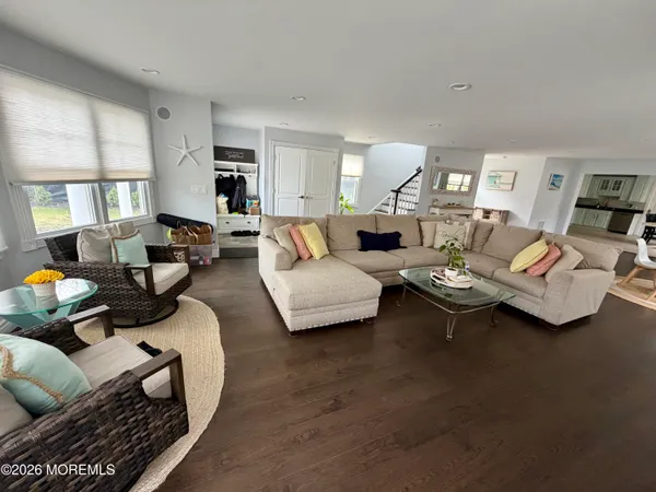 a living room with furniture fireplace and a large window