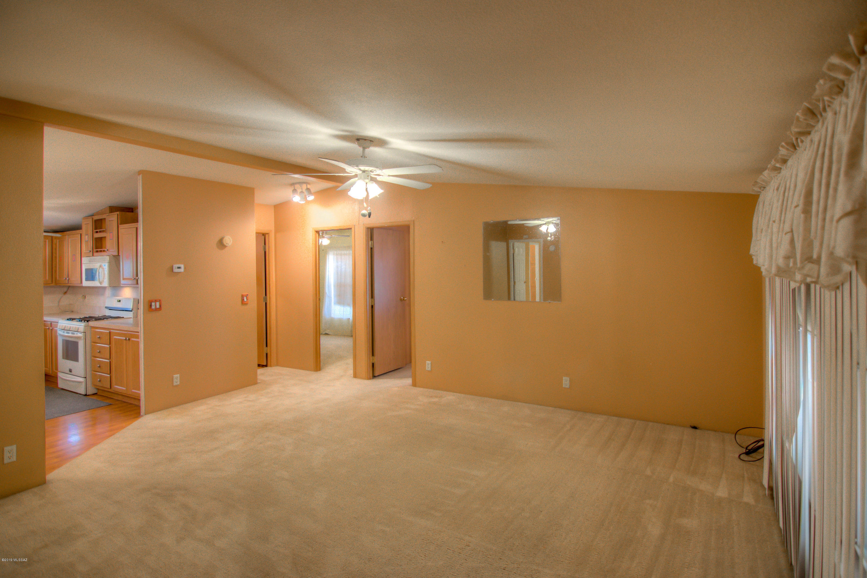263 East Roger Road Tucson, AZ 85705 - Photo 8 of 31 a view of an empty room with a kitchen