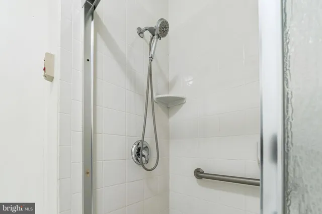 a view of a house with a floor to ceiling window and wooden fence