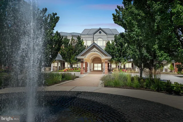 a view of a fountain with a tree in the background