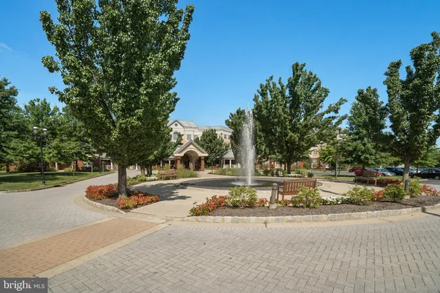 a living room with furniture and large windows