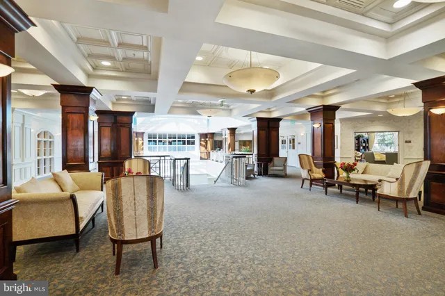a living room with furniture and a book shelf