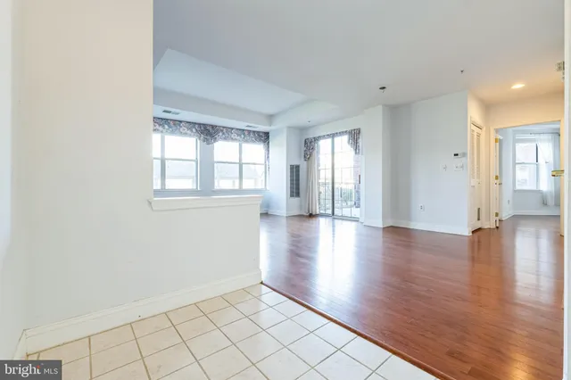 a kitchen with a refrigerator sink and cabinets