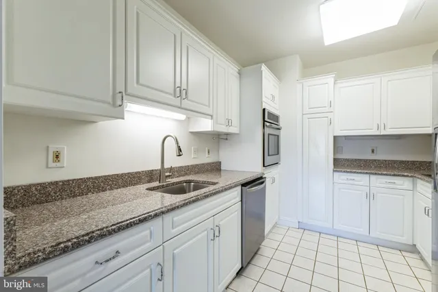 a kitchen with cabinets and stainless steel appliances