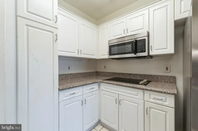 a kitchen with stainless steel appliances granite countertop a sink and a stove