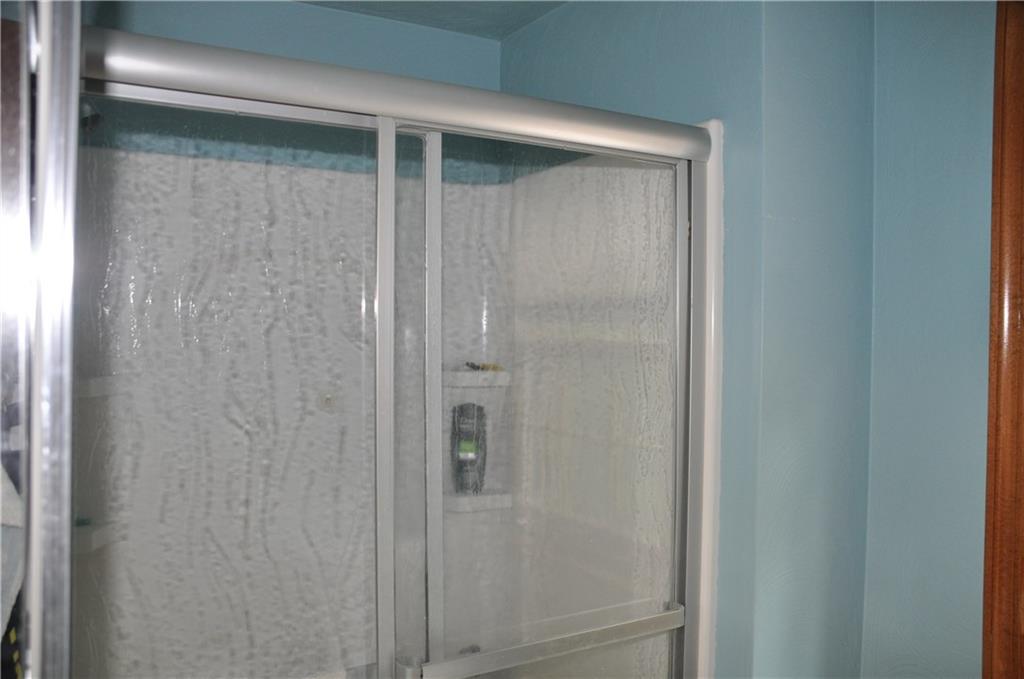 733 Greenlee Road Pittsburgh, PA 15227 - Photo 17 of 21 Updated hall bathroom with wide shower stall and white fixtures.