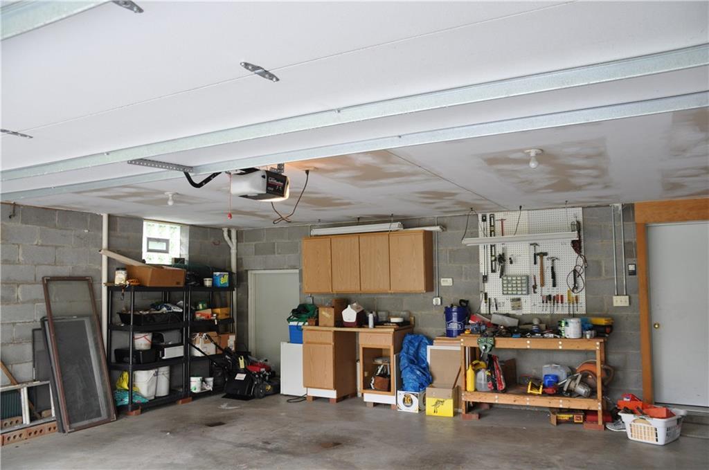 733 Greenlee Road Pittsburgh, PA 15227 - Photo 20 of 21 The wide 2 car garage has ample space for vehicles as well as a work bench and cabinets. The door on the left leads to additional storage for lawnmowers, tools, bikes, etc.