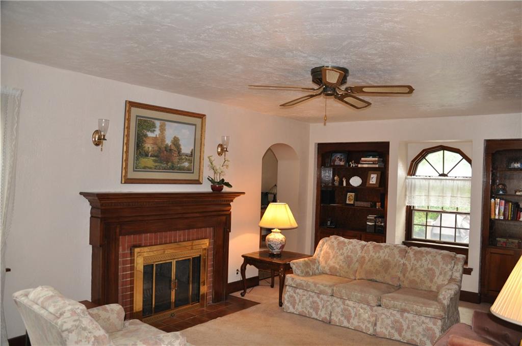 733 Greenlee Road Pittsburgh, PA 15227 - Photo 7 of 21 Curved archways and windows, built-in bookcases and a beautiful fireplace make this room so appealing. Hardwood floors are found under the carpet if you prefer.