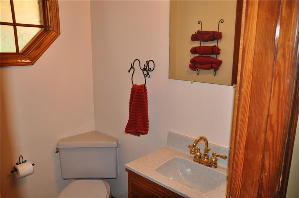 733 Greenlee Road Pittsburgh, PA 15227 - Photo 9 of 21 Freshly painted, the convenient first floor powder room features an octagonal window, and newer solid surface sink and vanity.