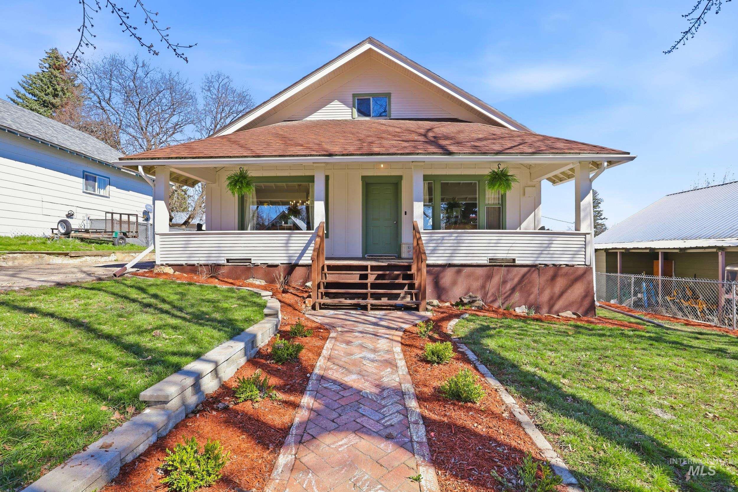 View of front of home featuring roof with shingles, covered porch, board and batten siding, and crawl space