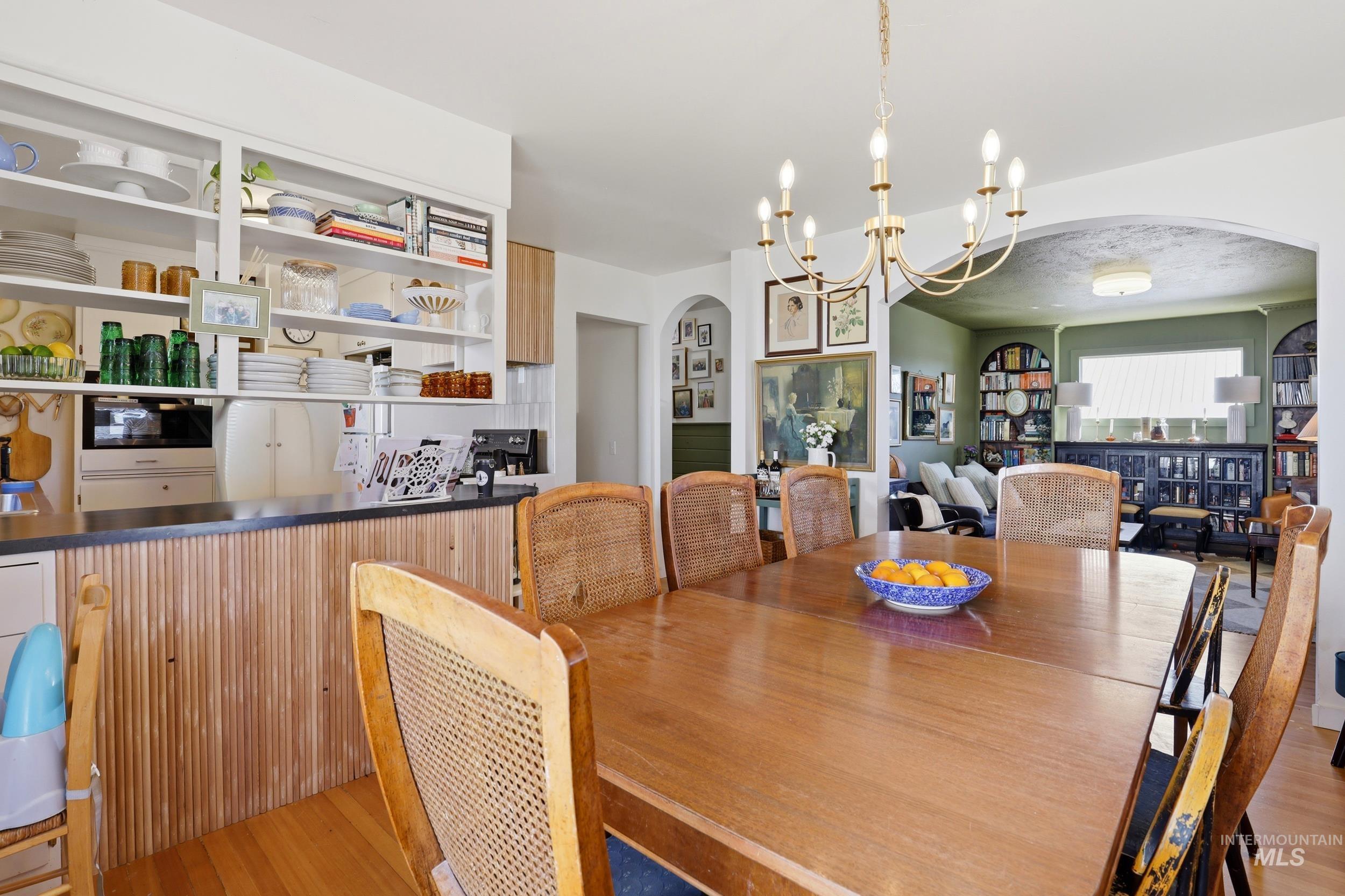 725 Elm Street Potlatch, ID 83855 - Photo 16 of 50 Dining room featuring arched walkways, hanging lights, and light wood finished floors