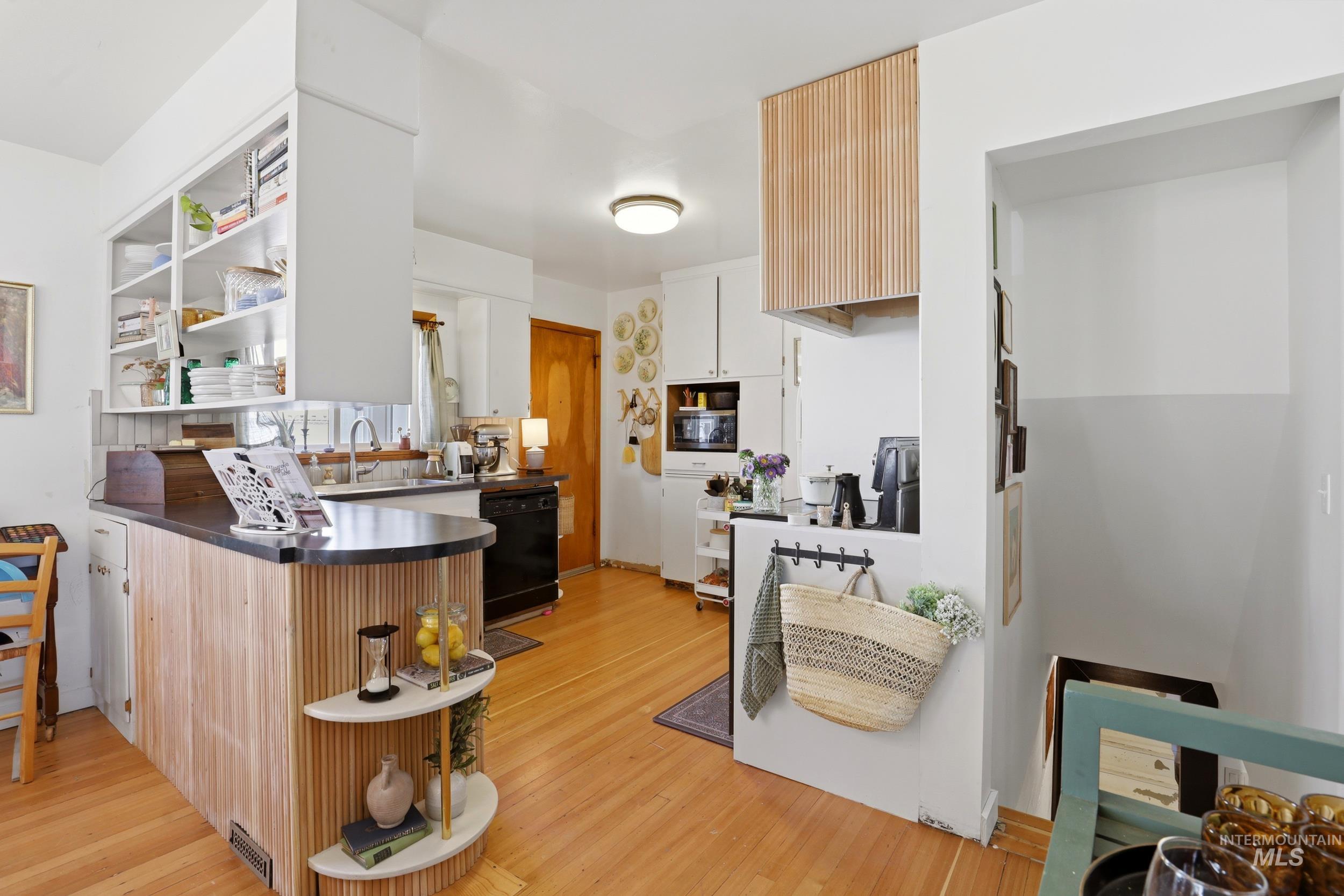 725 Elm Street Potlatch, ID 83855 - Photo 17 of 50 Kitchen featuring open shelves, dishwasher, light wood-style flooring, and a peninsula