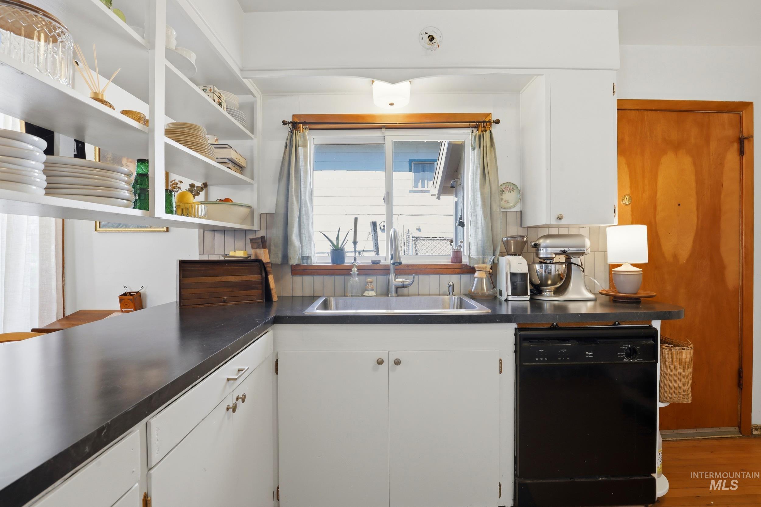 725 Elm Street Potlatch, ID 83855 - Photo 22 of 50 Kitchen featuring white cabinetry, dishwasher, dark countertops, and open shelves