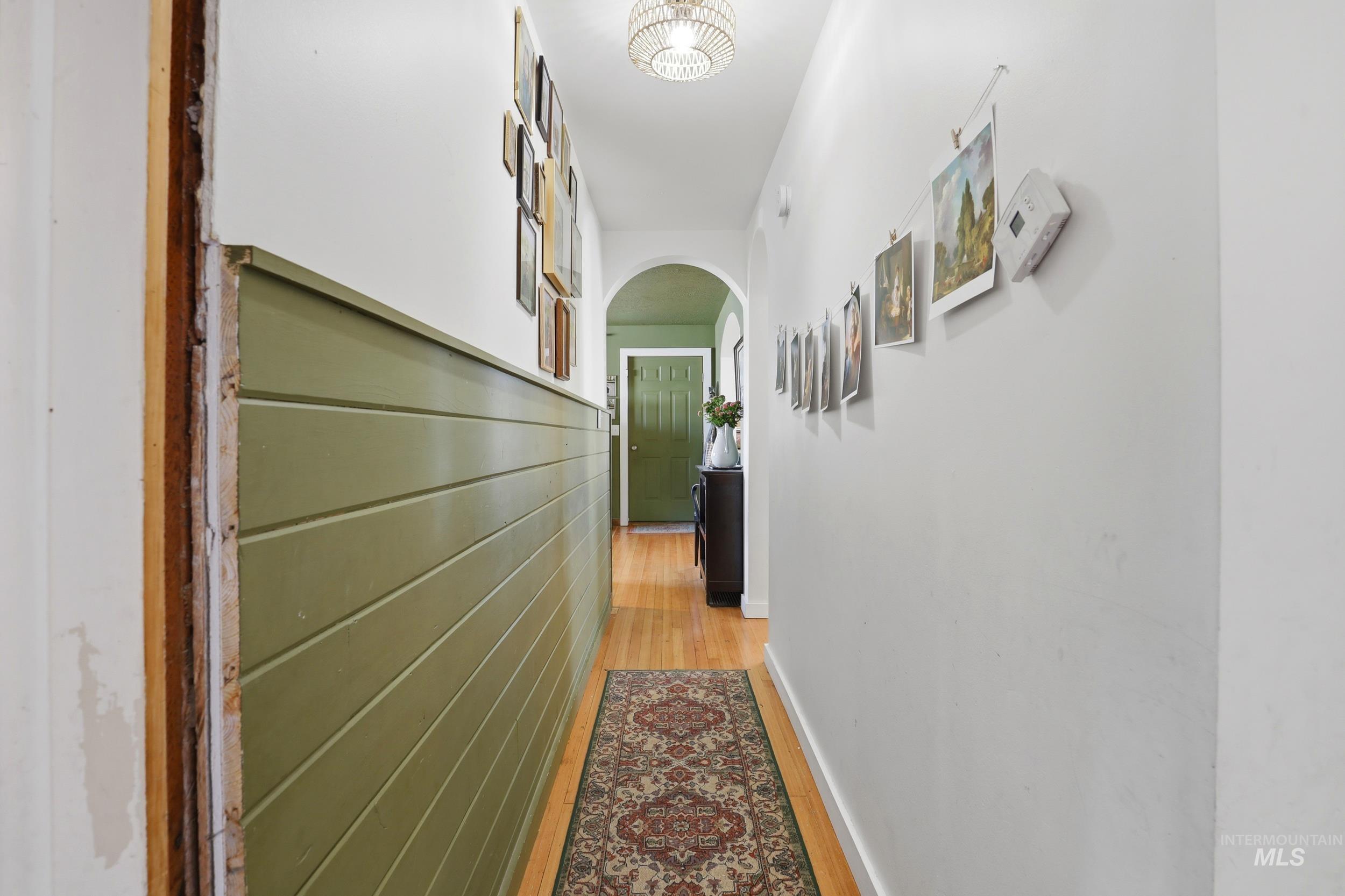 725 Elm Street Potlatch, ID 83855 - Photo 23 of 50 Hall with arched walkways and light wood finished floors