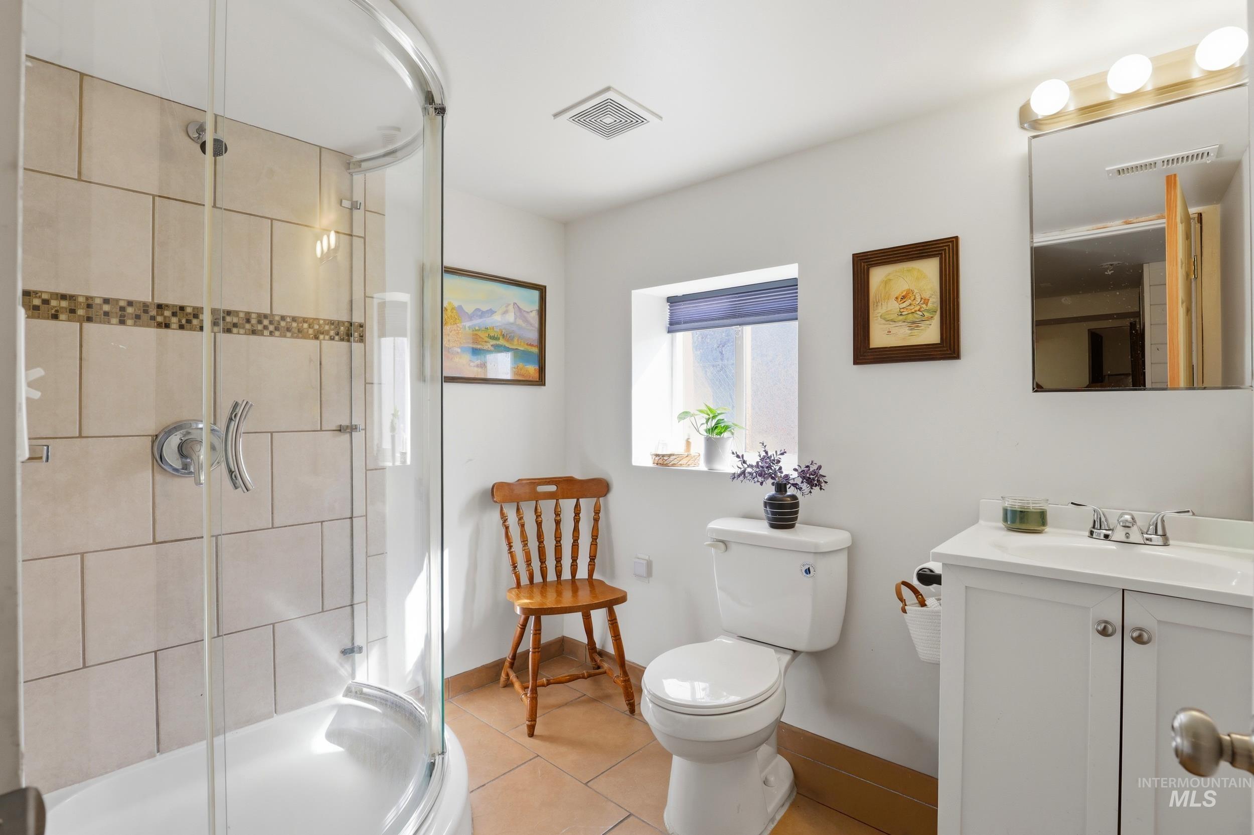 725 Elm Street Potlatch, ID 83855 - Photo 35 of 50 Bathroom with a shower stall, vanity, and light tile patterned flooring