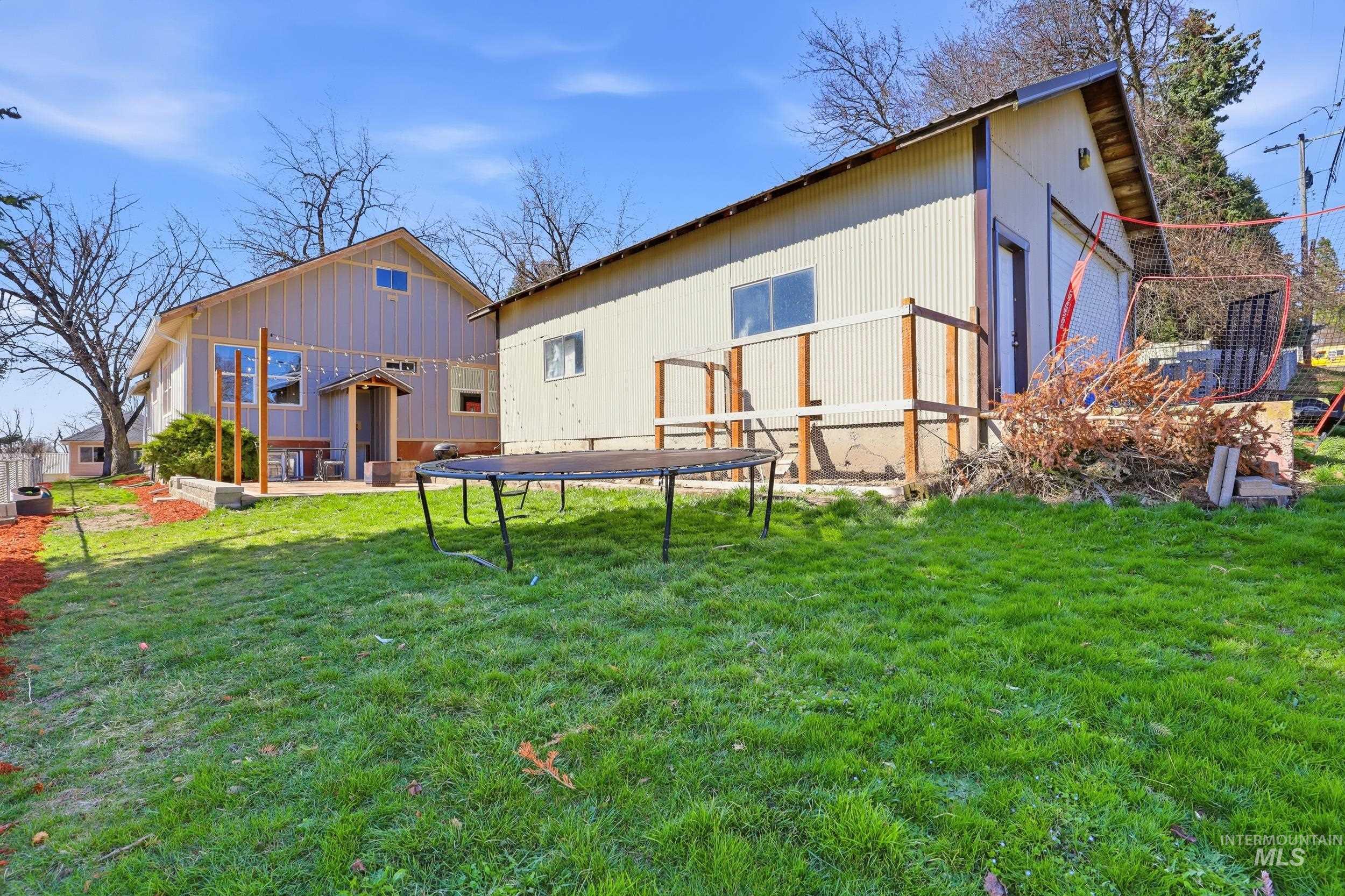 725 Elm Street Potlatch, ID 83855 - Photo 46 of 50 Rear view of house with a trampoline and a lawn