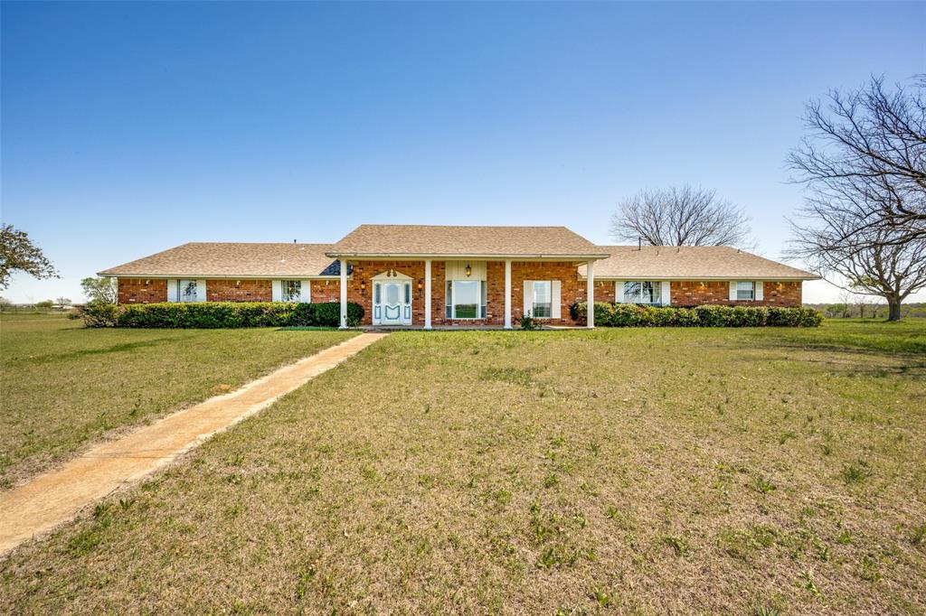 a front view of house with yard and outdoor seating