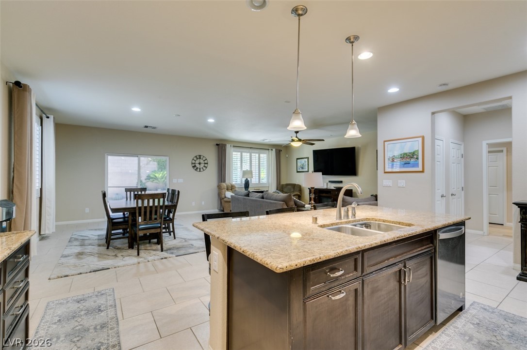 7375 Campbell Ranch Avenue Las Vegas, NV 89179 - Photo 43 of 45 A well-lit open floorplan connects kitchen, dining, and living spaces for effortless entertaining.