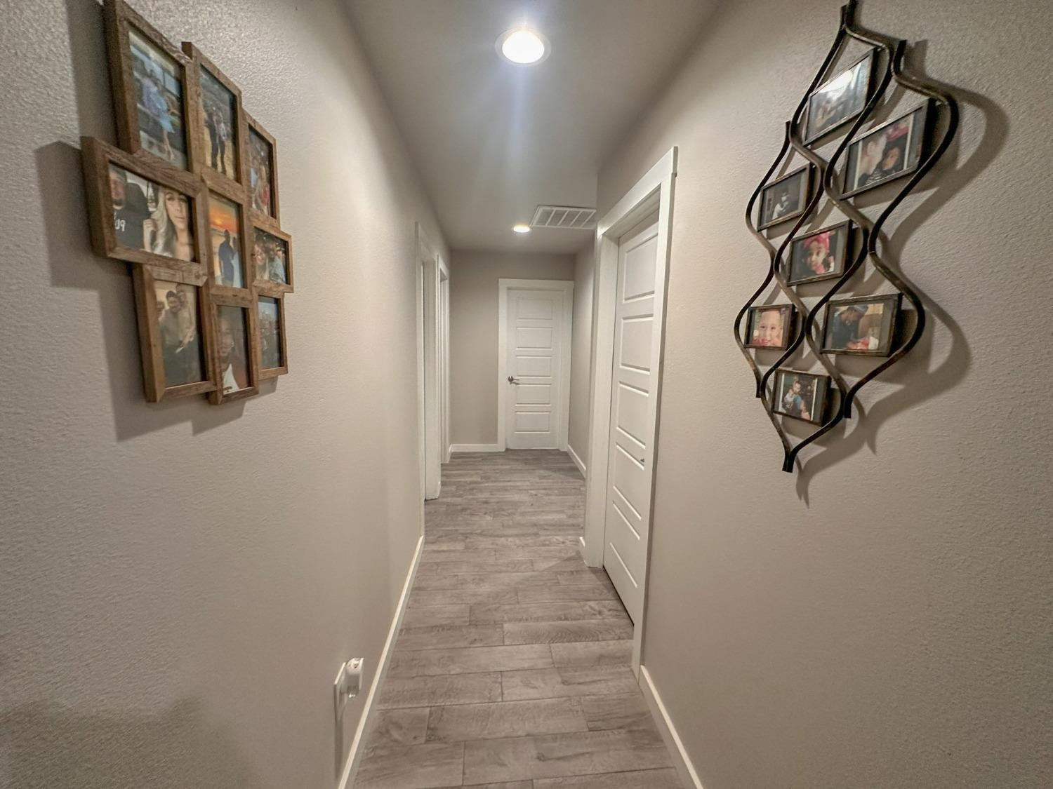 323 Ranger Street Wolfforth, TX 79382 - Photo 14 of 48 a view of a hallway with wooden floor