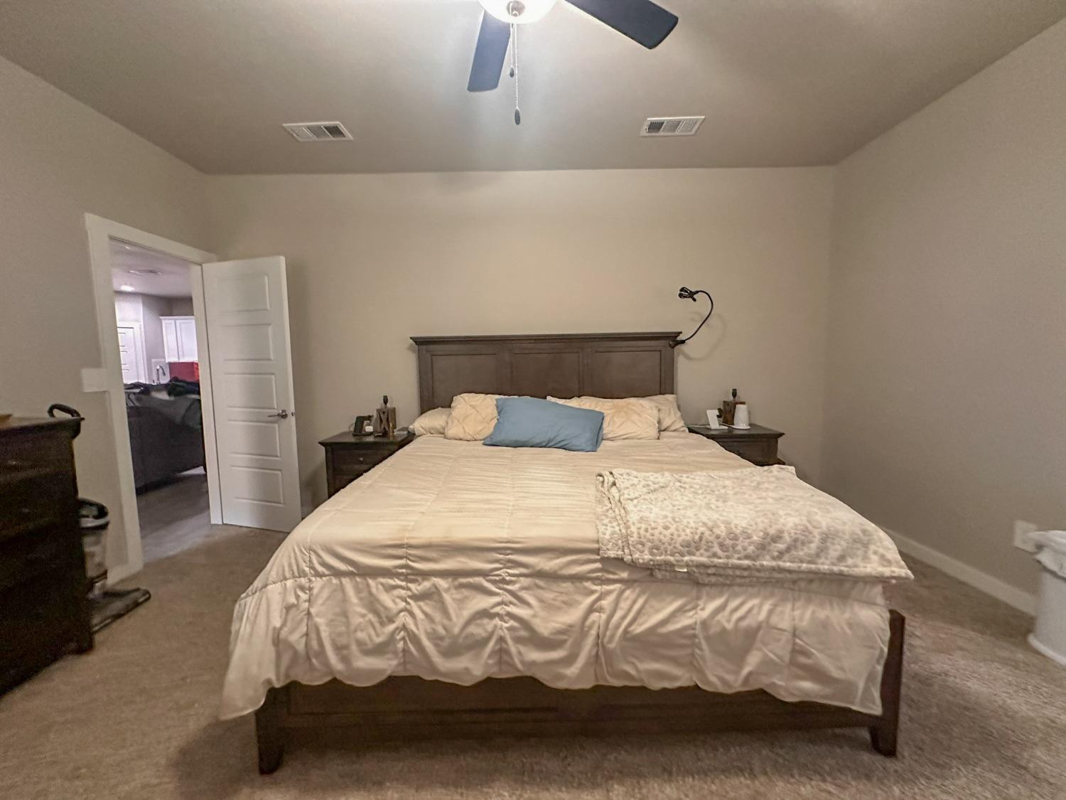 323 Ranger Street Wolfforth, TX 79382 - Photo 17 of 48 a large bed sitting in a bedroom next to a lamp