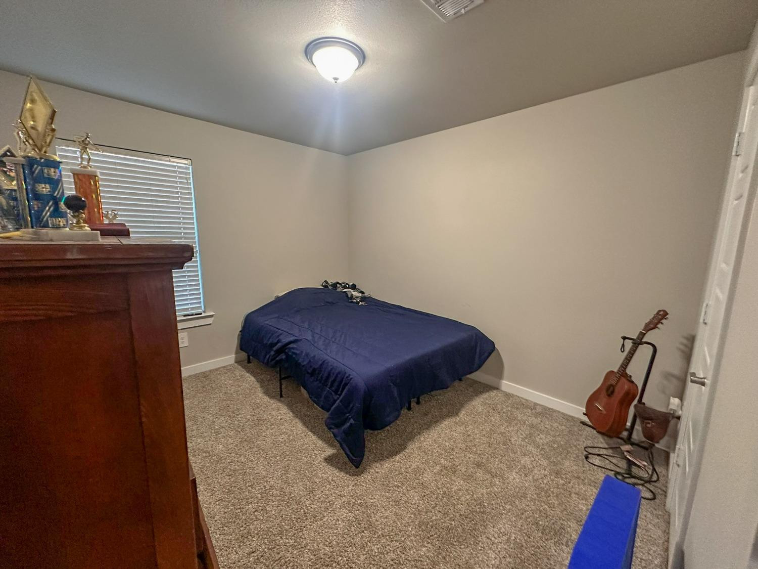 323 Ranger Street Wolfforth, TX 79382 - Photo 25 of 48 a bedroom with a bed and wooden floor