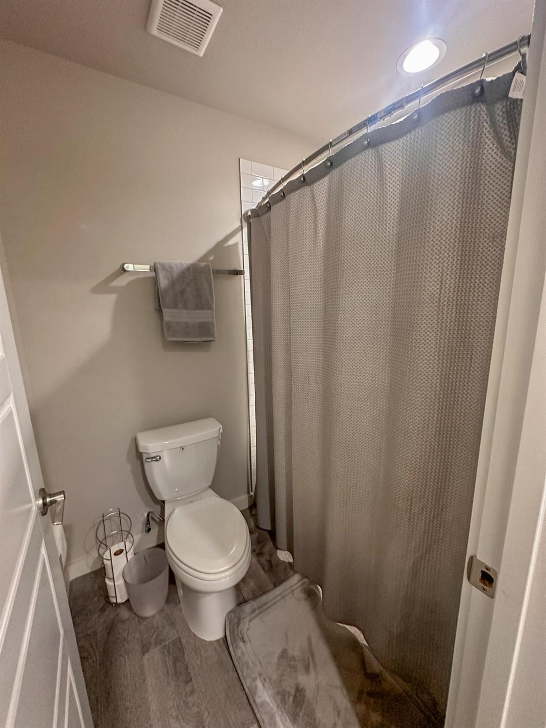 323 Ranger Street Wolfforth, TX 79382 - Photo 33 of 48 a white toilet sitting next to a shower curtain