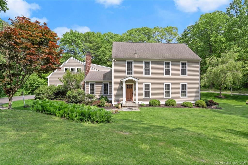 98 11 Levels Road Ridgefield, CT 06877 - Photo 1 of 1 a front view of a house with a yard table and chairs