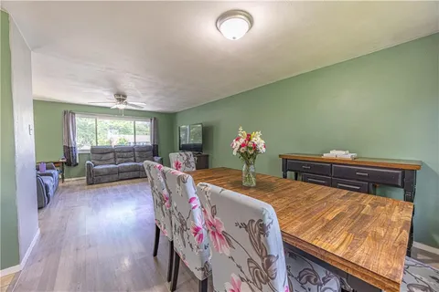 a dining room with furniture and wooden floor