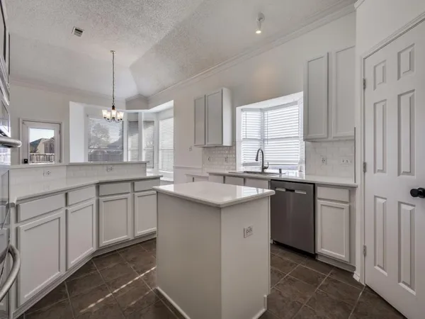 a kitchen with a sink stove and cabinets