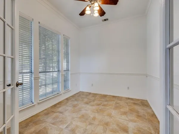 an empty room with a empty space and windows