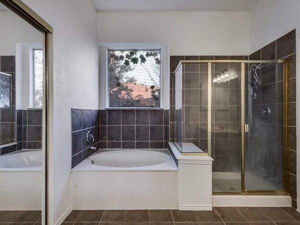 a bathroom with a bathtub and shower