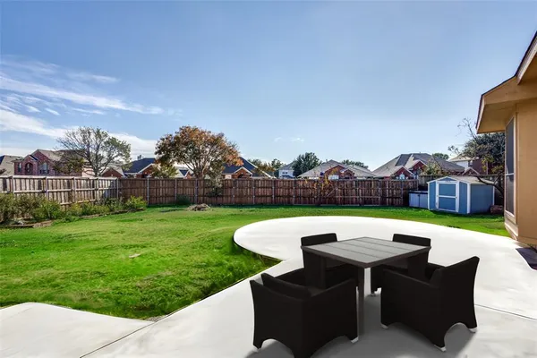 a view of a swimming pool and lounge chairs in back yard
