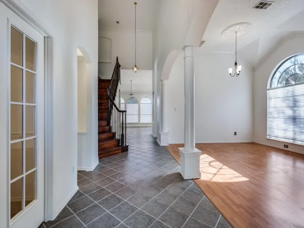 a view of a livingroom with wooden floor and stairs