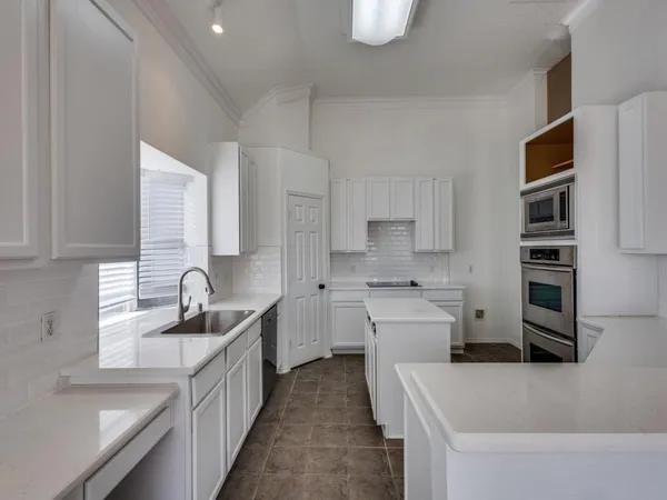 a kitchen with cabinets a sink and a stove