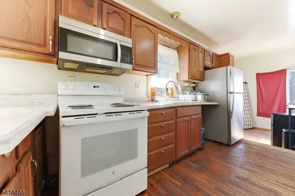 a kitchen with stainless steel appliances granite countertop a refrigerator stove and sink