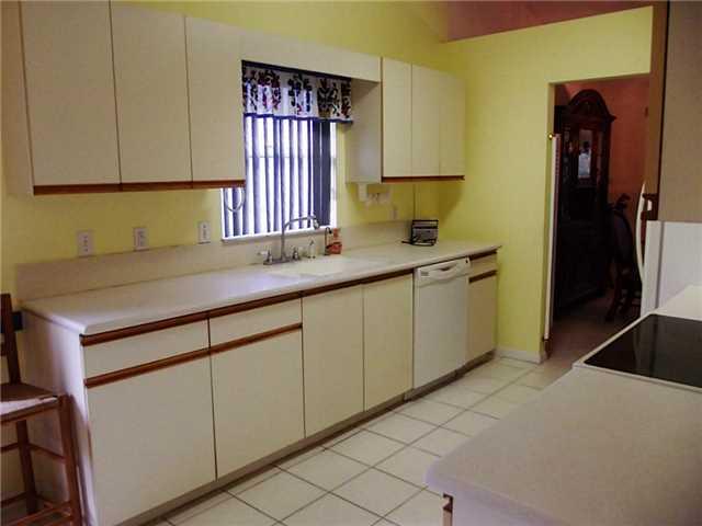 6940 Southeast Lillian Court Stuart, FL 34997 - Photo 11 of 25 a kitchen with a sink and cabinets