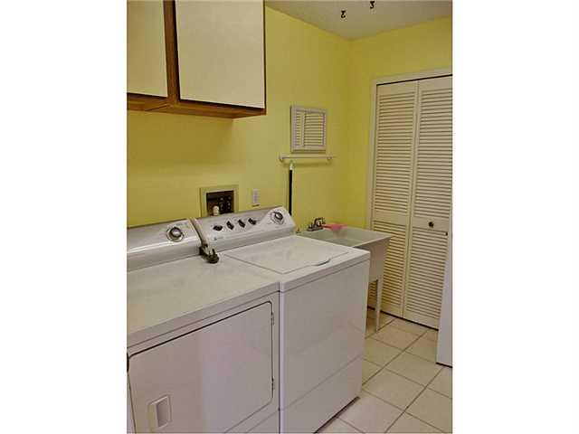 6940 Southeast Lillian Court Stuart, FL 34997 - Photo 13 of 25 a utility room with dryer and washer