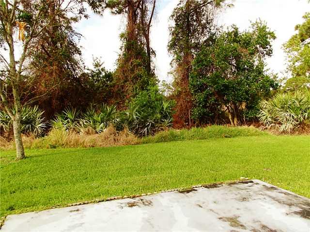 6940 Southeast Lillian Court Stuart, FL 34997 - Photo 16 of 25 a view of a yard with a tree