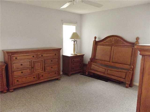6940 Southeast Lillian Court Stuart, FL 34997 - Photo 17 of 25 a room with a dresser and a mirror
