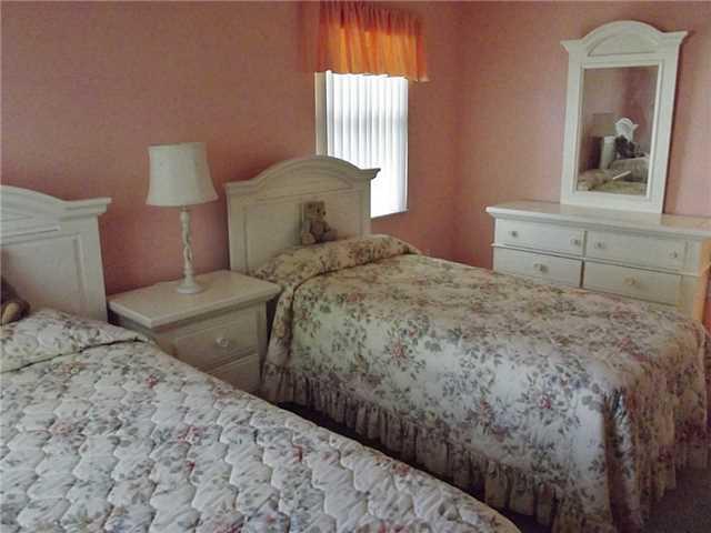 6940 Southeast Lillian Court Stuart, FL 34997 - Photo 19 of 25 a bedroom with a bed and a window