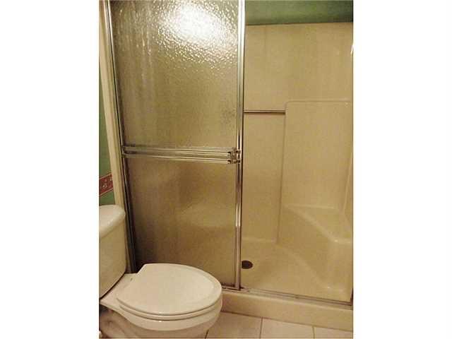 6940 Southeast Lillian Court Stuart, FL 34997 - Photo 21 of 25 a white toilet sitting next to a bathroom sink