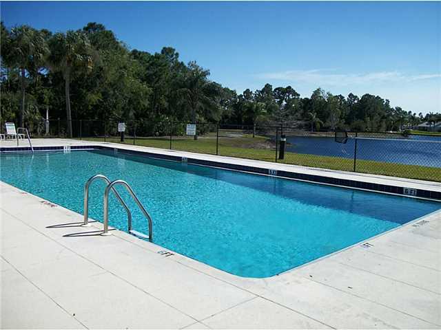 6940 Southeast Lillian Court Stuart, FL 34997 - Photo 22 of 25 a view of a swimming pool and a yard