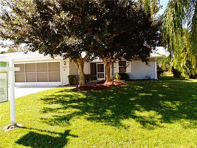 6940 Southeast Lillian Court Stuart, FL 34997 - Photo 3 of 25 a front view of a house with garden