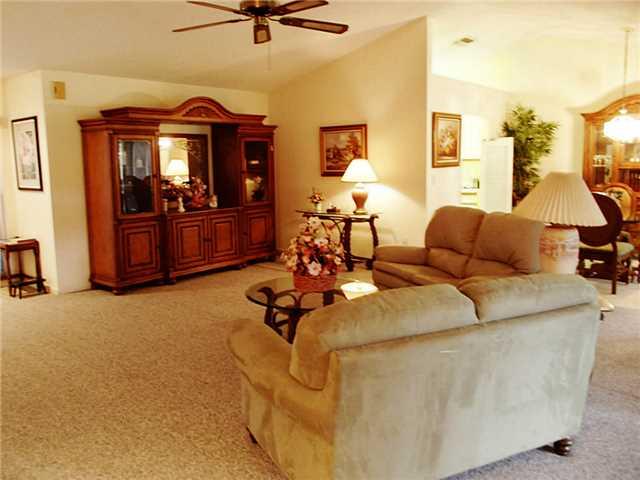 6940 Southeast Lillian Court Stuart, FL 34997 - Photo 4 of 25 a living room with furniture and a flat screen tv